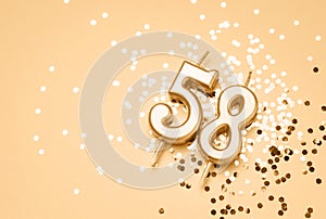58 years celebration festive background made with golden candle in the form of number Fifty-eight