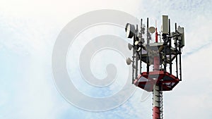 5G cell phone tower and microwave antenna mast against sky