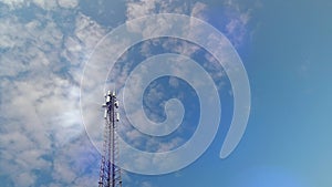 5G Cellular antenna tower and electronic radio transceiver equipment part of a cellular network under the blue sky. Radio