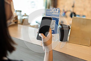 5G. customer using digital mobile phone scan QR code pay for buying coffee in modern cafe coffee shop, cafe restaurant, digital pa
