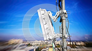 5G mobile telecommunication smart cellular radio network antennas on a mast on the roof broadcasting signal waves