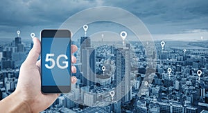 5G technology and internet network connection. Hand holding mobile smart phone using 5g technology