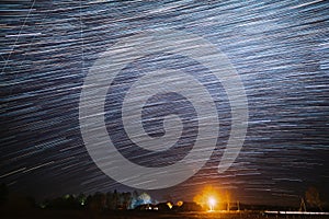 5k Night Starry Sky Above Village. Sky Background Over Rural Countryside Landscape. Meteors Cross Dark Blue Sky. Amazing