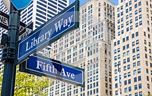 5th ave and Library Way corner. Blue color street signs, Manhattan New York downtown