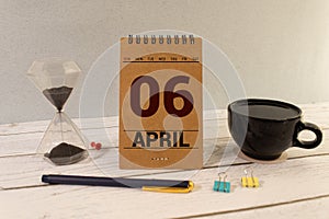 6 April on wooden grey cubes. Calendar cube date 06 April