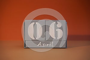 6 April on wooden grey cubes. Calendar cube date 06 April. Concept of date. Copy space for text. Educational cubes