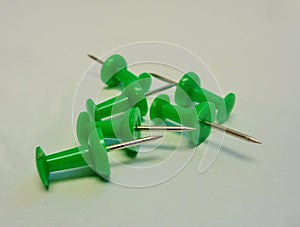 6 Green Push Pins on Grey Background