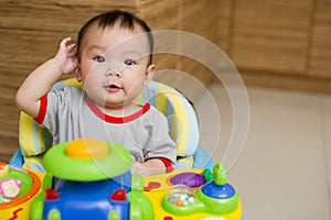 6 month old Asian baby girl smiling excitedly photo