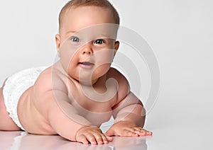 6 month old baby infant lies in one diaper on a light background