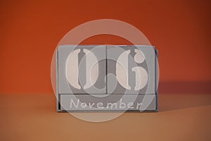 6 November on wooden grey cubes. Calendar cube date 06 November. Concept of date. Copy space for text. Educational cube