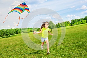 6 years old girl running with kite