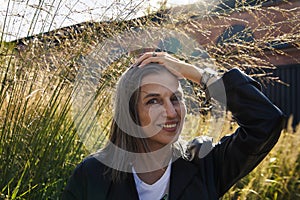 60-year-old European woman against  background of nature