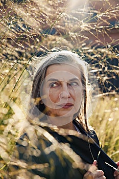 60-year-old European woman against  background of nature