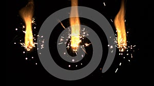 600fps super slowmotion fireworks: three golden sparklers, black background