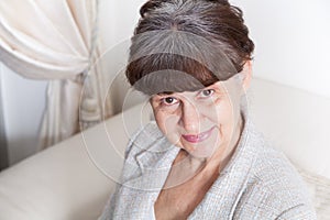 65 years old good looking woman portrait in domestic environment.