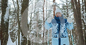 A 65s pensioner is engaged in sports in the winter forest, riding classic skins