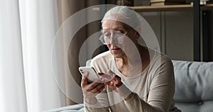 65s retired woman read sms on cellphone feels overjoyed