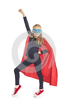 7 or 8 years old young female schoolgirl child in super hero costume performing happy and excited isolated on white background