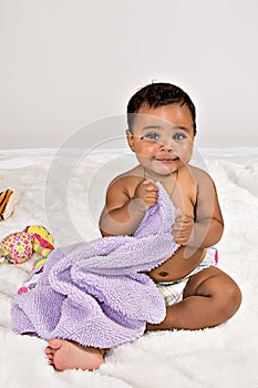 7 month old baby smiling with blanket