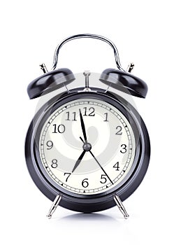 7 O` Clock on alarm clock on white