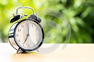 At 7 o`clock in the morning connect the time at for work with tree background copy space