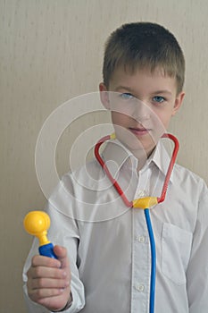 7 years boy as a doctor with toy instruments