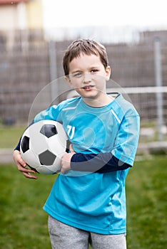 7 years boy - footballer with football ball.