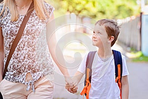 7 years old boy going to school with his mother