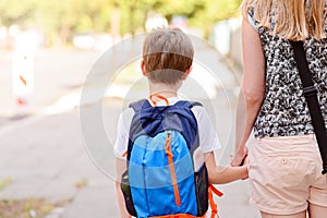 7 years old boy going to school with his mother