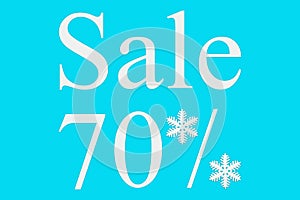 70 percent sale on a blue background, top view. Background for Christmas, new year, and winter sales. Seasonal discounts in stores