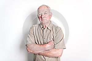 70 year old senior man standing isolated on white background