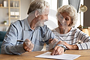 70s couple discuss agreement ready to sign contract