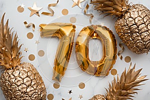 70th birthday celebration card with gold foil balloons and golden pineapples