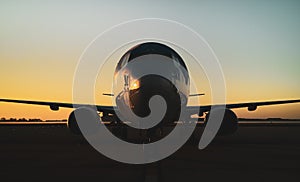 737 aircraft with sunset on tarmac apron ramp