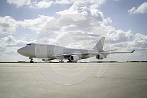 747 in white sat on the tarmac apron ramp ready to taxi