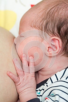 8 days old newborn baby girl during breastfeeding