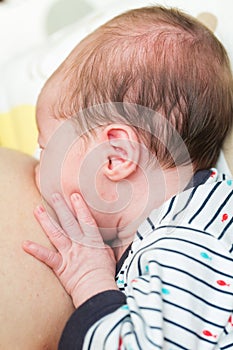 8 days old newborn baby girl during breastfeeding