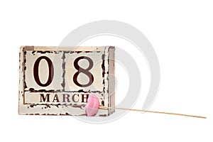 8 March Happy Women`s Day with wooden block calendar and pink lips on a stick, isolated on white