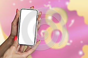 8 March International women& x27;s day. A woman holds a mockup of a smartphone in her hands on the background of a greeting card