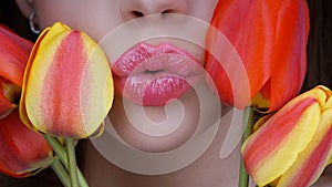 8 march women`s day. Woman with tulips kiss. Kissing. Lips and flovers close up.