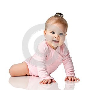 8 month infant child baby girl toddler lying in pink shirt learning to crawl