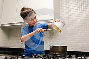 8 year old child pouring condensed milk into the pan and trying to eat it