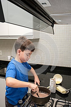 8 year old in the kitchen making a Brazilian sweet, brigadeiro brigadier