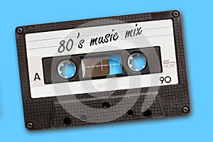 80`s music mix written on vintage audio cassette tape, blue background