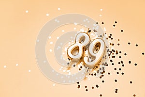 89 years celebration festive background made with golden candles in the form of number Eighty-nine