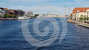 8K Copenhagen canal falls sunny day. Boat sails under the bridge. Gimbal-stabilized movement over the bridge