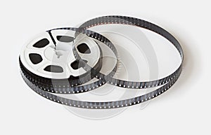 8mm film reel with film strips scattered around. Studio shot,