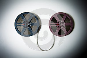 8mm movie reels connected with film in color effect