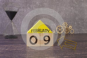 9 February on wooden grey cubes. Calendar cube date 09 February. Concept of date