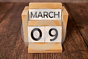 9 Marz on wooden grey cubes. Calendar cube date 09 March. Concept of date. Copy space for text or event. Educational